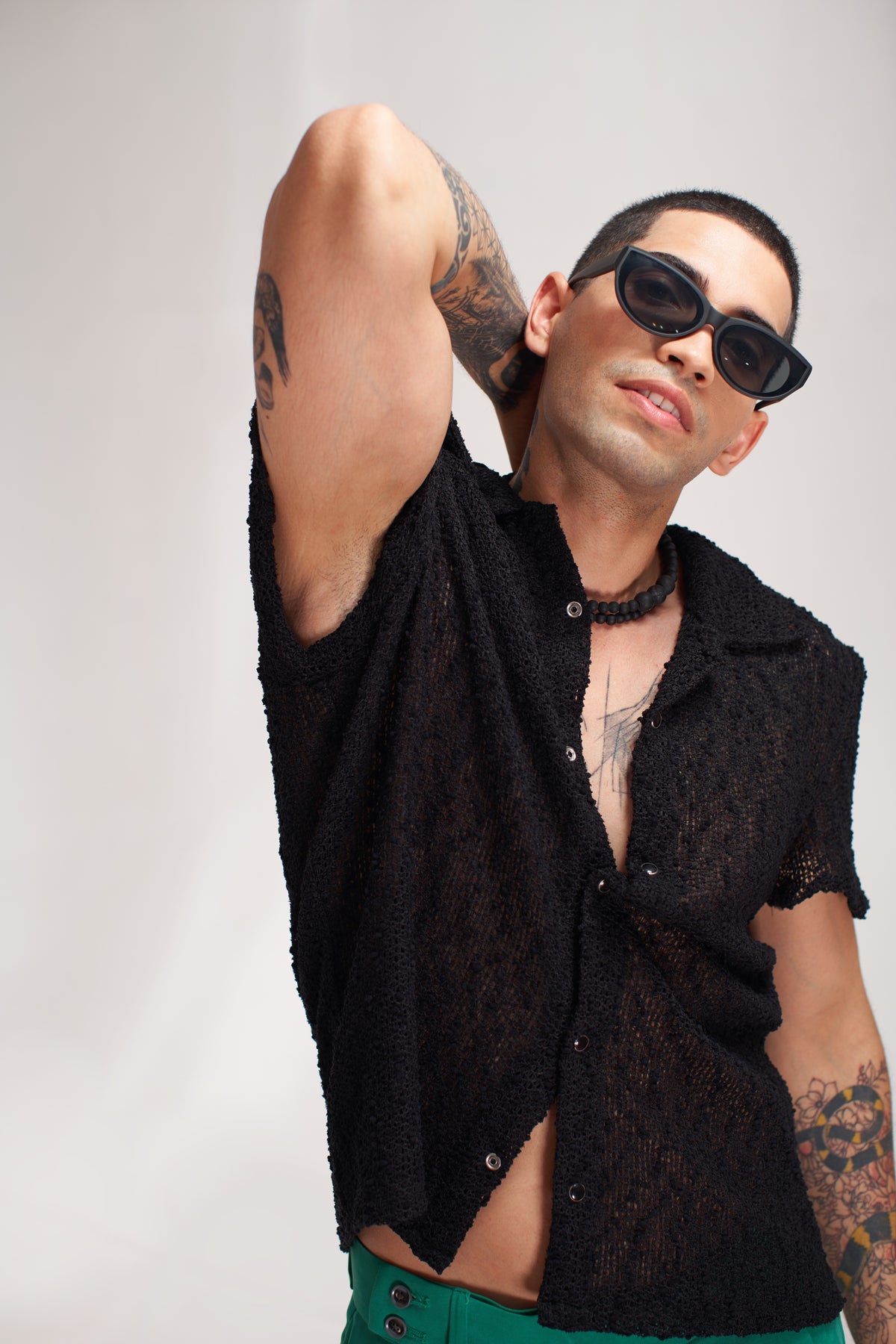 men black shirt green pent